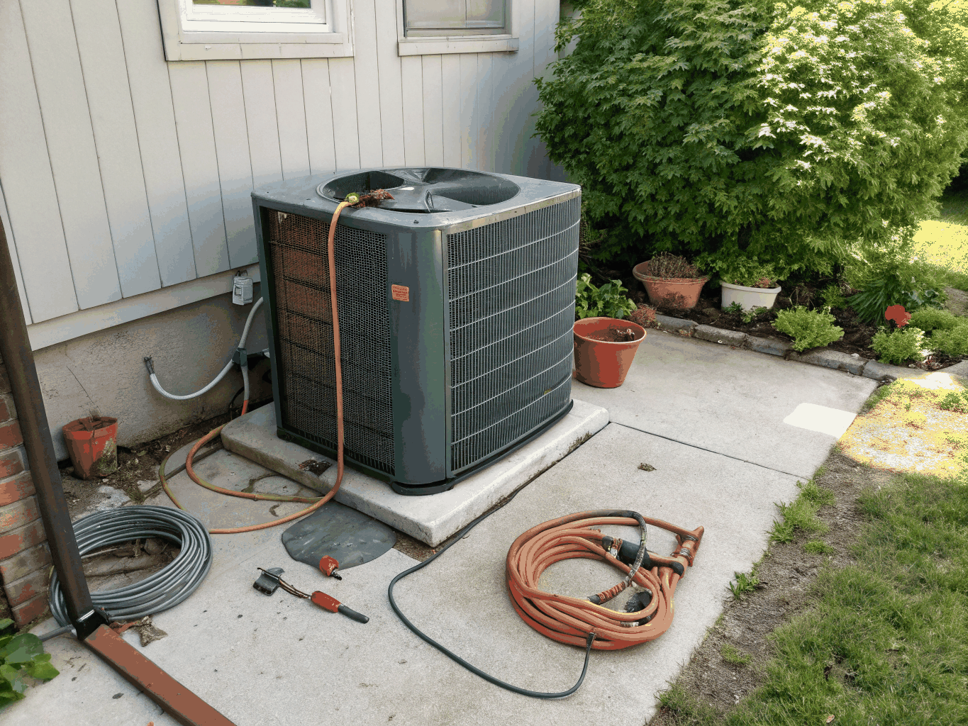 New energy efficient central AC condenser installation